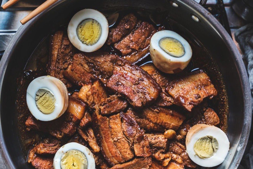 Filipino chicken adobo braised in soy sauce and vinegar, served with rice