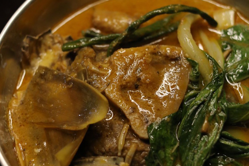Filipino kare-kare oxtail stew in a rich peanut sauce